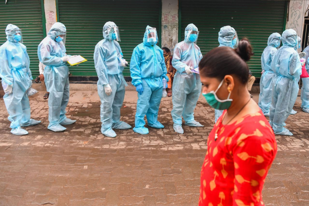 Medical-staff-and-Rashtriya-Swayamsevak-Sangh-(RSS)-volunteers-wearing-Personal-Protective-Equipment-wait-to-start-a-door-to-door-medical-screening-inside-a-slum-to-fight-against-the-spread-of-the-COVID-19-coronavirus-in-Mumbai-on-June-17,-2020-Photo:-Time